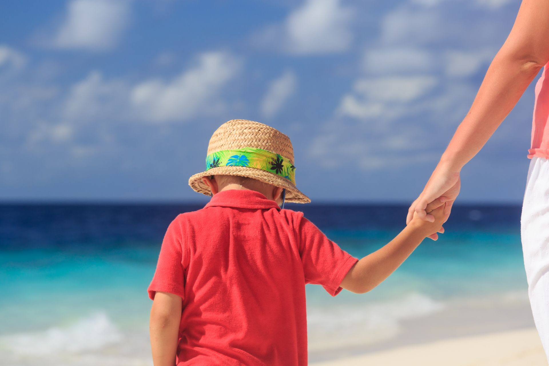 mother and son holding hands on tropical beach vacation mother and son holding hands on tropical beach vacation
